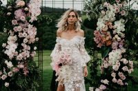 a jaw-dropping wedding backdrop done of pink, blush and white blooms, greenery and foliage is a very refined and chic idea