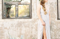 a light blue wedding dress with a fitting lace up bodice and a very deep neckline plus a pleated maxi skirt