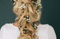 a loose braided and wavy half updo with baby’s breath tucked in looks very boho-like and very springy