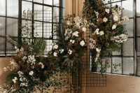 a lovely dried wedding backdrop of foliage, greenery, white and blush blooms and lot sof dried touches to enliven the space
