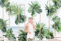 a lush tropical wedding backdrop of plywood with lots of tropical leaves and a sea view is ideal for a tropical wedding