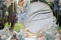 a lush wedding backdrop with lots of ombre blooms from white to blue is a fairy-tale like thing