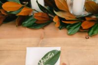 a magnolia leaf garland and a magnolia leaf card is a cool idea to style your wedding tablescape