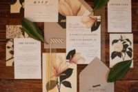a magnolia wedding invitation suite in neutrals, with printed blooms and leaves