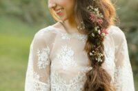 a messy twisted braid with some waxflower and berries tucked into hair is a lovely boho chic wedding idea
