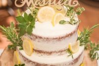 a naekd wedding cake with herbs, lemon slices and a calligraphy cake topper is a fantastic idea for spring or summer
