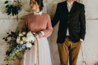 a peachy pink sweater over a pink high neckline wedding dress for a colorful touch