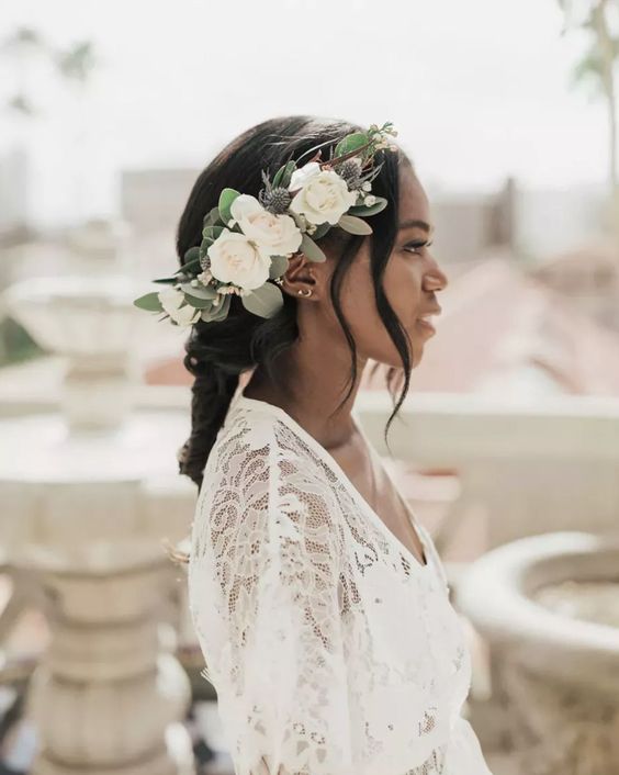 a pretty and delicate flower crown with white blooms, greenery and thistles is a stylish idea to accessorize a apsring bridal look