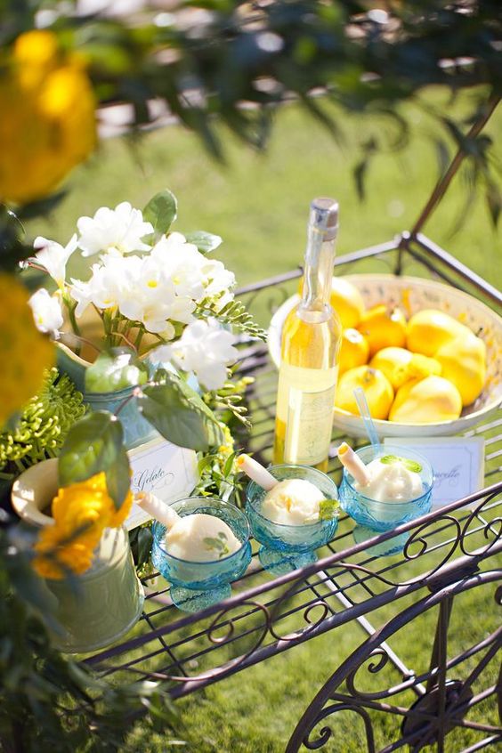 a refined vintage ice cream cart with white blooms, lemons in a bowl, ice cream and some wine is ideal for a summer wedding