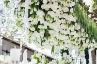 a super lush and bold overhead wedding installation made of white tulips is a fantastic idea for an elegant wedding