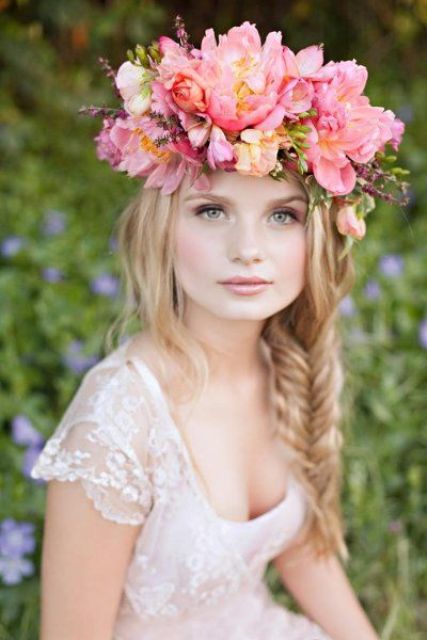 a super lush and statement floral crown of pink blooms and a bit of greenery for a spring or summer bride is amazing