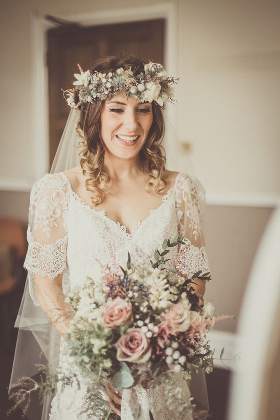 a textural and chic neutral flower crown with white and blush blooms, greenery, berries and thistles is amazing for a boho bride