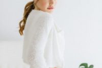 a very cozy white fluffy angora sweater over the wedding dress looks sophisticated