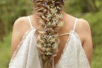 a voluminous twisted braid with white and blue flowers tucked in will be a nice solution for a spring or summer boho bride