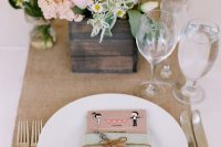 a wedding manu in a mint-colored pocket with twine and a cardboard heart is a lovely idea for a rustic wedding