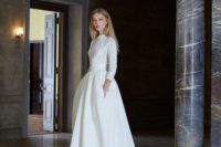 a white cable knit sweater with long sleeves over an A-line wedding gown