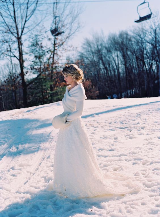 a white wrap sweater over the wedding dress looks very elegant and refined