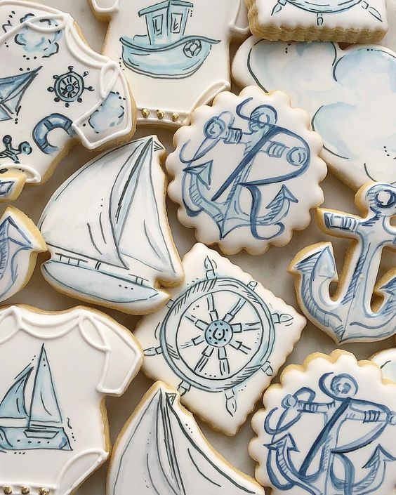 an assortment of nautical cookies with anchors, steering wheels, boats, ships and much more is idea for a nautical wedding