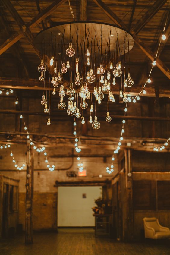 an industrial chandelier with lots of bulbs hanging down is a beautiful way to decorate and accent your wedding dance floor