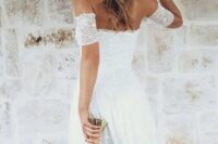 an off the shoulder lace wedding dress, flowers in hair are ideal for a spring boho bride
