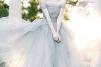 an off the shoulder slate grey wedding ballgown with a draped bodice and a layered full skirt