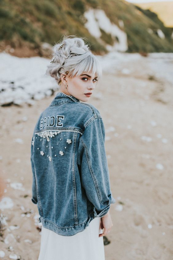 an oversized blue denim bridal jacket with letters and embellishments is a nice boho coverup