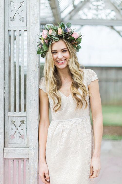 an oversized floral crown with pink, peachy blooms, lots of greenery and thistles is a gorgeous idea for a spring bride