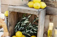 beautiful wedding station decor with crates, olive branches and lemons is a lovely idea for a rustic wedding