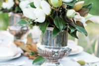 elegant vintage wedding centerpieces of silver urns and lush magnolias – blooms and leaves for chic decor