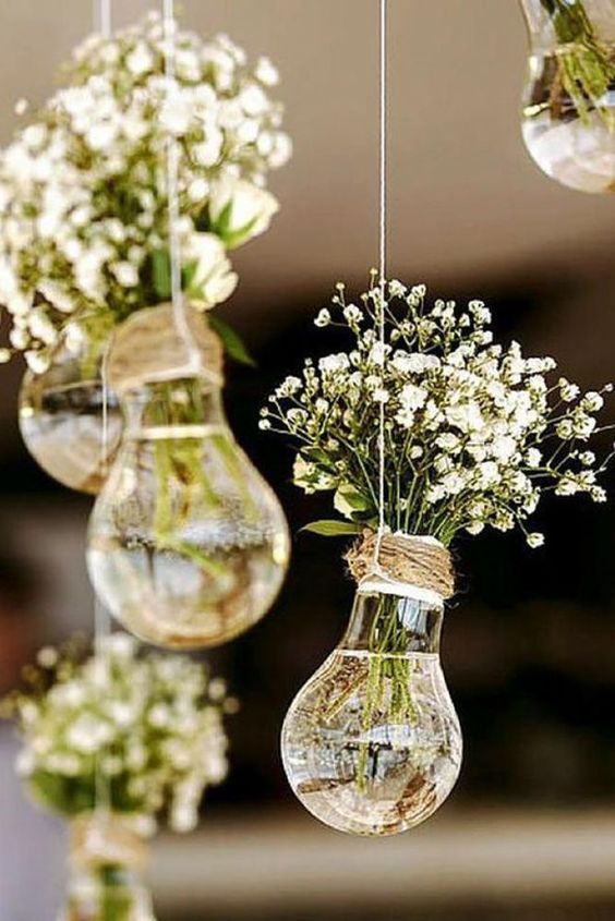 hanging bulbs with baby's breath are a cool and pretty rustic wedding decoration for a relaxed celebration