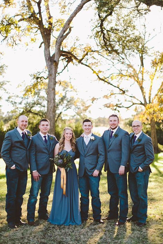 the groom and groomsmen wearing jeans and blazers for a more relaxed and fun look