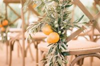 wooden chairs accented with olive branches and lemons are amazing for styling a wedding aisle at an Italian wedding