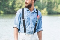 an informal groom’s look with white jeans, a blue chambray shirt and suspenders is very relaxed