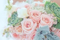 a large wedding bouquet of pink roses, large succulents, white blooms and some pale greenery is a delicate and chic idea