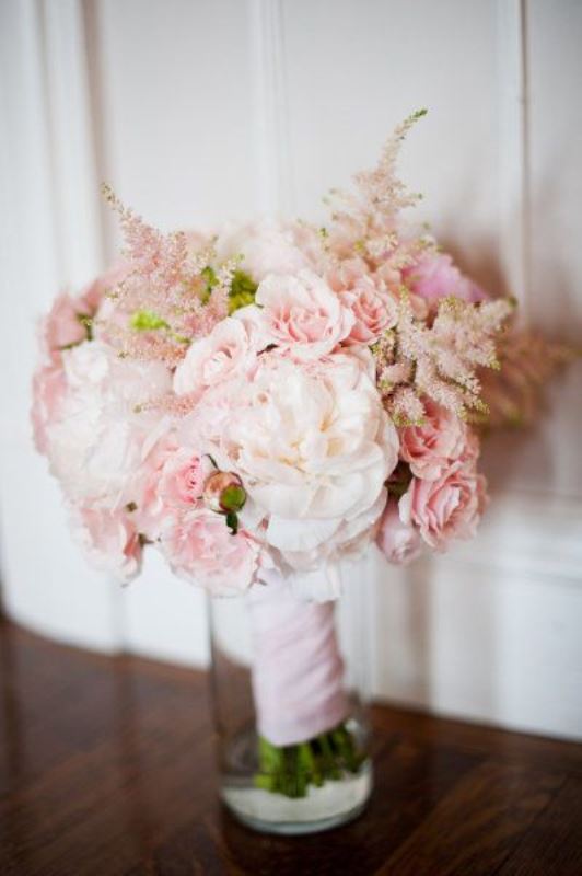 a pretty wedding bouquet of light pink blooms, white ones and just a bit of greenery is a gorgeous idea with a subtle feel
