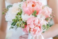 a large wedding bouquet of white and coral pink peonies and greenery for a spring or summer wedding is a lovely idea