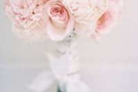 a light pink and neutral wedding bouquet with lace ribbons is a traditional and chic idea for a spring or summer wedding