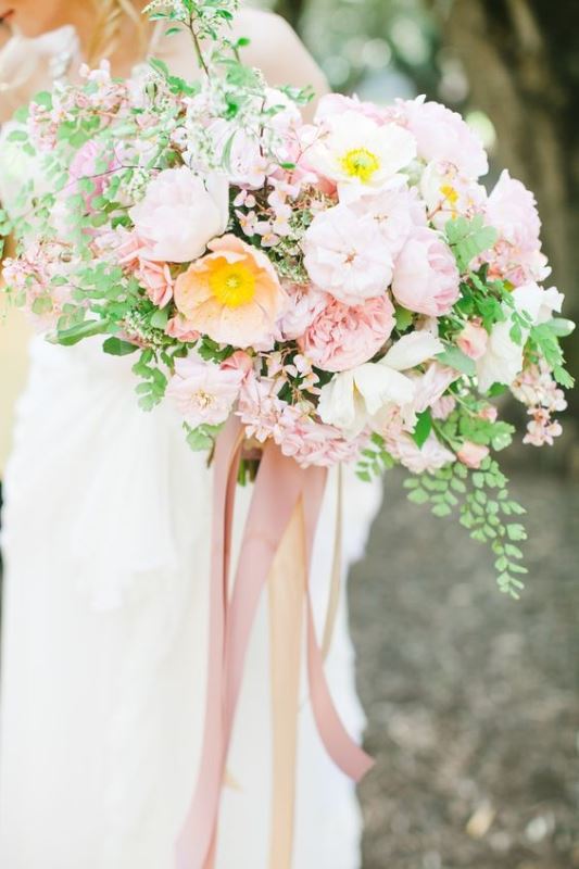 a lush light pink wedding bouquet with lots of greenery, much texture and pink ribbons is a fantastic solution for a spring wedding