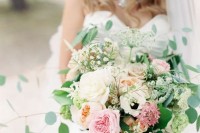a textural and dimensional wedding bouquet of white roses, blush peony roses and pink blooms, greenery and twigs is a cool idea