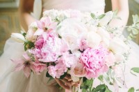 a large lush wedding bouquet of white blooms and beautiful pink ones plus long pink ribbons is a cool idea for a spring or summer wedding
