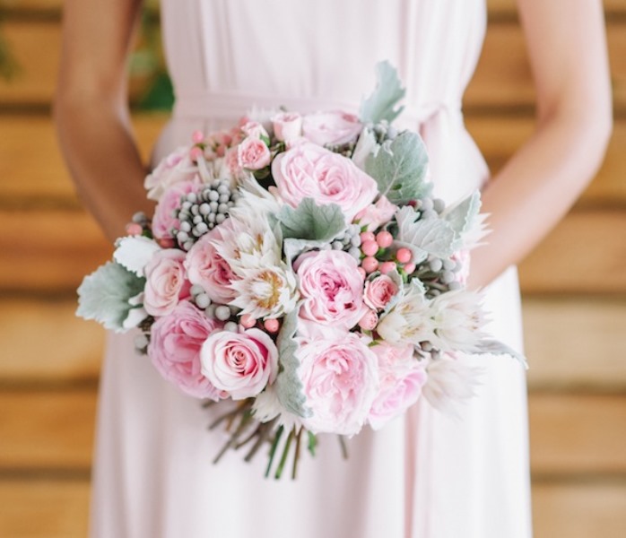 a light pink wedding bouquet with pale foliage and various berries is a catchy and pretty idea for every season including winter