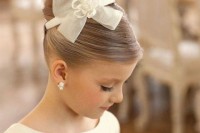 a very formal hairstyle with a sleek top and a very sleek top knot accented with a bow is a cool idea for a formal wedding, with a retro feel or a vintage touch