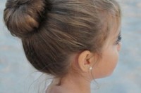 a classic top knot wiht a touch of mess and curls down is a lovely idea for all kinds of weddings and wedding styles