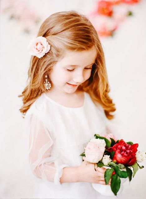 waves down accented with a single pink bloom is a very stylish, chic and cute idea that will match any flower girl look
