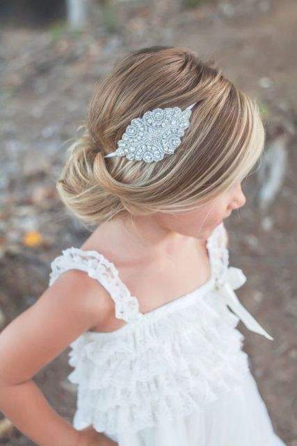 a voluminous low bun with a bump and an embellished hairpiece will be perfect for a refined formal or vintage wedding