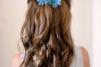 a long wavy half updo with blue silk flowers for an accent is a lovely and beautiful idea that will match many flower girl looks