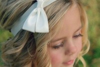 curls with a bump and a silk ribbon with a bow are amazing and super cute and will fit any flower girl’s look
