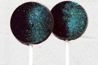 black and turquoise glitter galaxy-inspired lollipops are amazing for a space-themed wedding