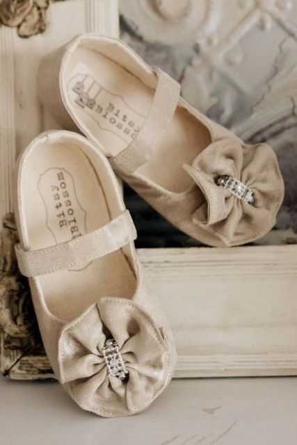neutral fabric strap flat shoes with large fabric bows and rhinestones are cute and chic and will match many flower girl looks