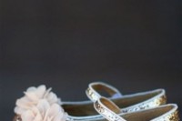 flat gold glitter shoes with ankle straps and pink fabric blooms on top are shiny and girlish touches to the flower girl’s look